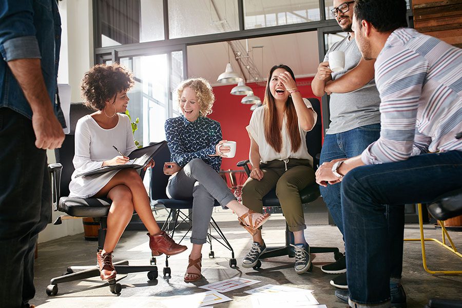 Employee Benefits - Cheerful Employees Sitting In Office During Meeting