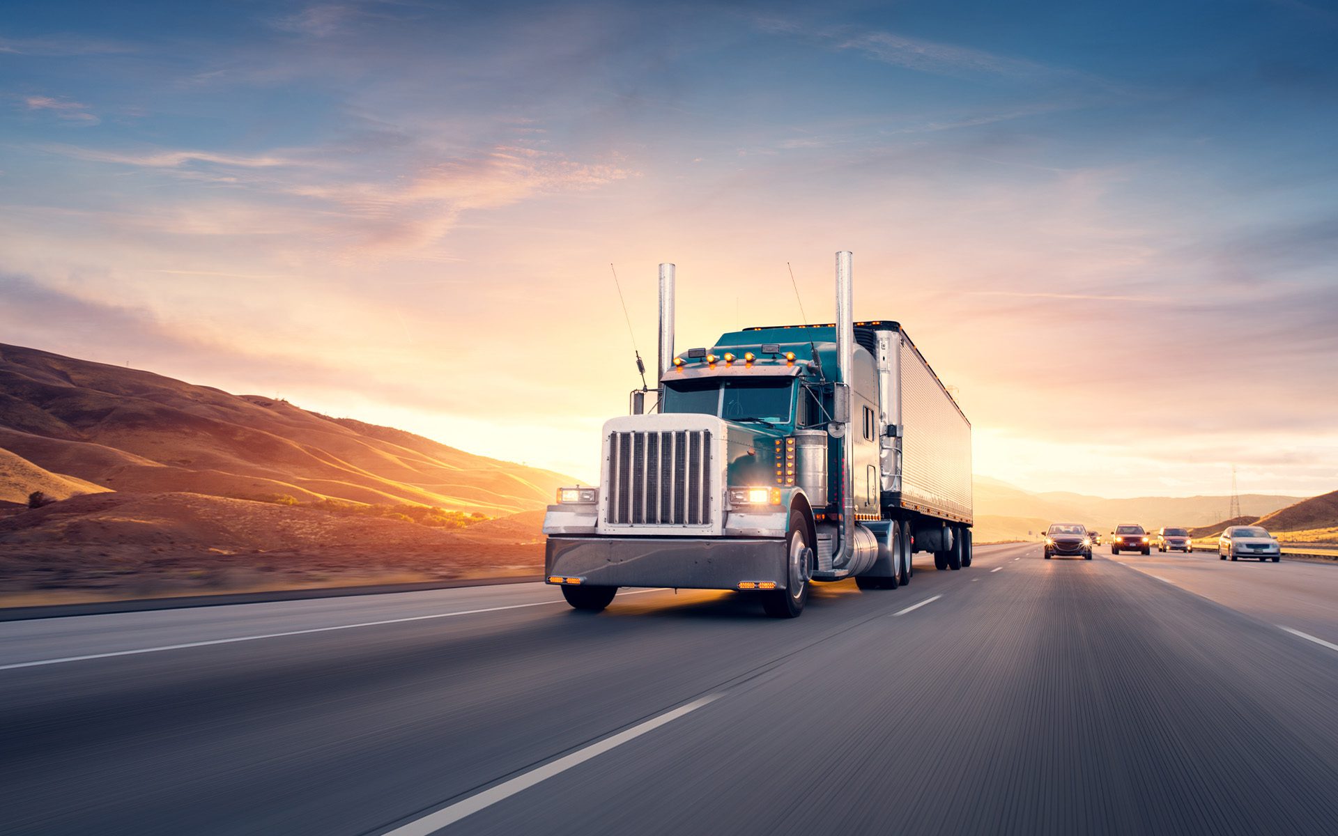 Homepage - Truck Driving on Highway at Sunset